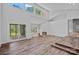 Spacious living room featuring high ceilings, fireplace, wood floors and multiple windows at 640 Lochaven Rd, Weddington, NC 28173