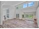 Bright and airy living room featuring high ceilings, wood floors, and large windows with scenic views at 640 Lochaven Rd, Weddington, NC 28173