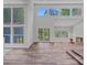 Sunlit living room with high ceilings, fireplace, wood floors and multiple windows with scenic views at 640 Lochaven Rd, Weddington, NC 28173