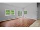 Bright living room featuring hardwood floors, natural light, and backyard access at 640 Lochaven Rd, Weddington, NC 28173