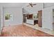 Open living room featuring a view into the kitchen and hardwood floors at 640 Lochaven Rd, Weddington, NC 28173