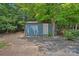 View of the backyard storage shed, blending seamlessly with the home's exterior and the surrounding landscape at 640 Lochaven Rd, Weddington, NC 28173