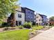 Elegant townhomes with manicured lawns, mature trees, and brick and siding exteriors at 6531 Hazelton Dr, Charlotte, NC 28210