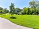 Expansive green space with a walking path, manicured lawn, and a central fountain feature at 6531 Hazelton Dr, Charlotte, NC 28210