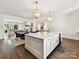 Bright, open kitchen featuring a large island, pendant lighting, and hardwood floors at 6531 Hazelton Dr, Charlotte, NC 28210