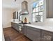 Modern kitchen featuring stainless steel appliances, gray cabinets and bright white subway tile backsplash at 6531 Hazelton Dr, Charlotte, NC 28210