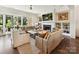 Inviting living room featuring a fireplace, built-in shelves, and large windows at 6531 Hazelton Dr, Charlotte, NC 28210