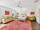 Spacious main bedroom featuring a sitting area, soft natural light, and a colorful rug at 6531 Hazelton Dr, Charlotte, NC 28210