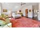 Bright bedroom featuring a sitting area, soft natural light, and access to the ensuite bathroom at 6531 Hazelton Dr, Charlotte, NC 28210