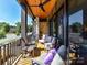 Relaxing porch with ceiling fan, comfortable seating, and view of the street at 6531 Hazelton Dr, Charlotte, NC 28210