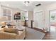 Comfortable sitting area with patterned chairs, a small tv, and natural light from two windows at 6531 Hazelton Dr, Charlotte, NC 28210