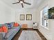 Cozy sitting room featuring a comfortable sofa, ceiling fan, and sun-filled window with pleasant views at 6531 Hazelton Dr, Charlotte, NC 28210
