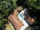 Expansive aerial view of the property featuring the pool, patio, garden, and surrounding landscape at 6745 Lancer Dr, Charlotte, NC 28226