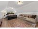 Bright bedroom featuring a comfortable seating area, bed, and natural light at 6745 Lancer Dr, Charlotte, NC 28226
