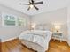 This bedroom features a ceiling fan, wood floors, and large windows at 6745 Lancer Dr, Charlotte, NC 28226