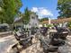 Backyard firepit area with Adirondack chairs, adjacent to a charming white home at 6745 Lancer Dr, Charlotte, NC 28226