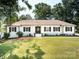 Charming white brick home with well-manicured lawn, dark shutters, and inviting front entrance at 6745 Lancer Dr, Charlotte, NC 28226