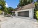 Spacious detached garage with a dark, modern door and adjacent patio at 6745 Lancer Dr, Charlotte, NC 28226
