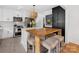 Contemporary kitchen featuring an island with seating, white cabinets, and stainless steel appliances at 6745 Lancer Dr, Charlotte, NC 28226