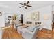 Bright living room boasts hardwood floors, stylish furnishings, and seamless access to the modern kitchen at 6745 Lancer Dr, Charlotte, NC 28226
