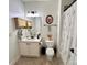 Bright bathroom featuring a white vanity, framed mirror and floral shower curtain at 7076 Brookstone Ln, Fort Mill, SC 29707