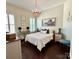 This cozy bedroom features a wood frame bed, neutral decor, and two windows at 7076 Brookstone Ln, Fort Mill, SC 29707