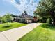 Well maintained house exterior, large driveway, manicured lawn and landscaped gardens at 7076 Brookstone Ln, Fort Mill, SC 29707