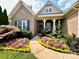 Charming brick home with colorful flowers, shutters and a welcoming front porch at 7076 Brookstone Ln, Fort Mill, SC 29707