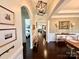 Elegant hallway featuring arched doorways, hardwood floors, and stylish decor at 7076 Brookstone Ln, Fort Mill, SC 29707