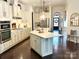 Bright kitchen with a large island, white cabinets, pendant lighting, and stainless steel appliances at 7076 Brookstone Ln, Fort Mill, SC 29707