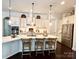 Spacious white kitchen with a large island, modern appliances, and bar stool seating at 7076 Brookstone Ln, Fort Mill, SC 29707