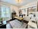 A home office featuring a light wood desk, built-in shelves, and a window with shutters at 7076 Brookstone Ln, Fort Mill, SC 29707