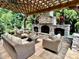 Covered patio featuring an outdoor stone fireplace and comfortable seating for entertaining guests at 7076 Brookstone Ln, Fort Mill, SC 29707