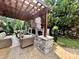 A spacious outdoor living area, featuring stone fireplace, pergola and ample seating at 7076 Brookstone Ln, Fort Mill, SC 29707