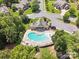 Aerial view of kidney shaped pool surrounded by trees, seating, and neighboring upscale houses at 7076 Brookstone Ln, Fort Mill, SC 29707