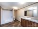 Well-lit bathroom featuring wood-look flooring, a modern vanity, and a tub and shower combination at 716 Sharon Ln, Iron Station, NC 28080