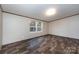 A large bedroom features wood floors, two windows, and ample light from the exterior at 716 Sharon Ln, Iron Station, NC 28080