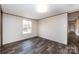 Bright bedroom with wood-look flooring and a window, offering a serene and inviting space at 716 Sharon Ln, Iron Station, NC 28080
