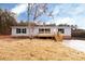 Charming single-story home featuring neutral siding, black shutters, and a wooden porch and steps at 716 Sharon Ln, Iron Station, NC 28080