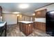 Open eat-in kitchen features an island, and lots of counter space with wood cabinets and modern appliances at 716 Sharon Ln, Iron Station, NC 28080