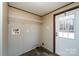 Laundry room with a wire shelf, utility connections, and an exterior door with a window at 716 Sharon Ln, Iron Station, NC 28080