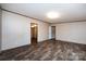 A large living area features wood floors, and access to a bathroom and an open doorway at 716 Sharon Ln, Iron Station, NC 28080