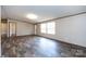 Expansive living room with abundant natural light, neutral colored walls, and plank flooring at 716 Sharon Ln, Iron Station, NC 28080