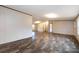 Open-concept living area with plank flooring, neutral-colored walls, and access to other rooms at 716 Sharon Ln, Iron Station, NC 28080