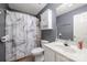 Well-lit bathroom featuring vanity, toilet, and marble-patterned shower curtain at 7518 Silver Arrow Dr, Charlotte, NC 28273