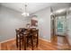 Cozy dining area features a wooden table, setting for four, and hardwood flooring at 7518 Silver Arrow Dr, Charlotte, NC 28273
