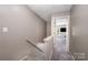 Upstairs hallway featuring carpet floors, neutral colors and access to bedrooms at 7518 Silver Arrow Dr, Charlotte, NC 28273