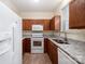 Functional kitchen featuring granite countertops, wood cabinets and modern white appliances at 7518 Silver Arrow Dr, Charlotte, NC 28273