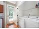 Convenient laundry room features a washer, dryer, and access to the backyard at 7518 Silver Arrow Dr, Charlotte, NC 28273