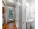 Hallway with powder room featuring pedestal sink and neutral tones at 7518 Silver Arrow Dr, Charlotte, NC 28273